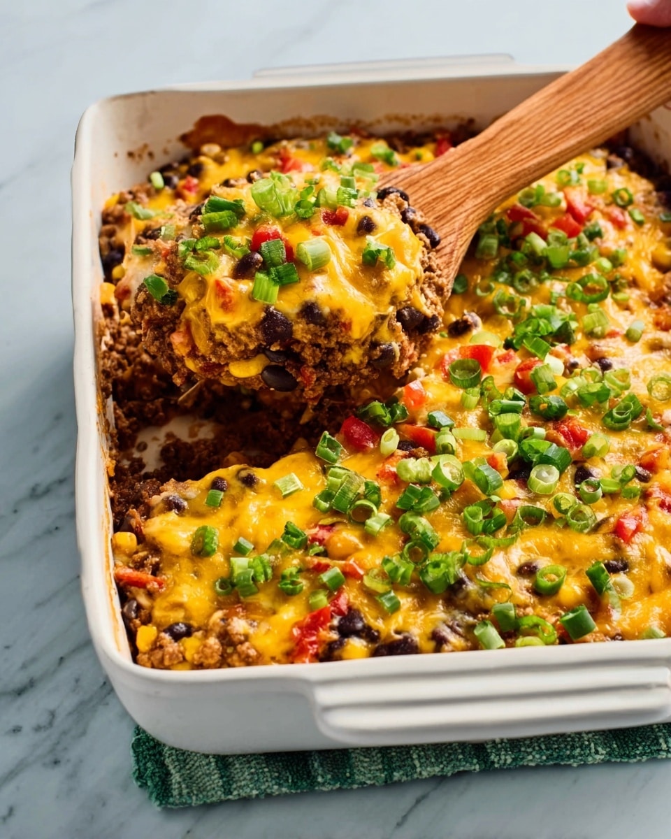 The image shows a white rectangular baking dish filled with a colorful casserole that has several visible layers. The bottom layer looks like cooked black beans mixed with ground meat, showing a dark and brown textured base. Above this, there is a layer of melted yellow cheese that covers the dish unevenly, with some parts uplifting as a wooden spoon lifts a portion from the corner. On top, there is a final layer of chopped bright green scallions scattered evenly, adding a fresh contrast. There are also small bits of red tomato or pepper mixed within the casserole, adding pops of red throughout. The dish is placed on a white marbled surface, and a woman's hand holds the wooden spoon. photo taken with an iphone --ar 4:5 --v 7