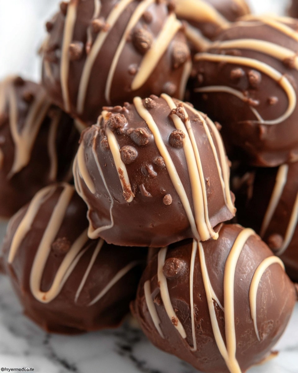 The image shows several round chocolate truffles placed closely together on a white marbled surface. Each truffle has one smooth dark brown chocolate layer as the base, covered by a lighter brown chocolate drizzle that adds a textured, shiny streak pattern on top. The drizzle varies in thickness and runs in random lines across each truffle, creating a contrast between the solid base and the glossy toppings. The truffles have a glossy, rich appearance, suggesting a soft and creamy inside. Photo taken with an iphone --ar 4:5 --v 7
